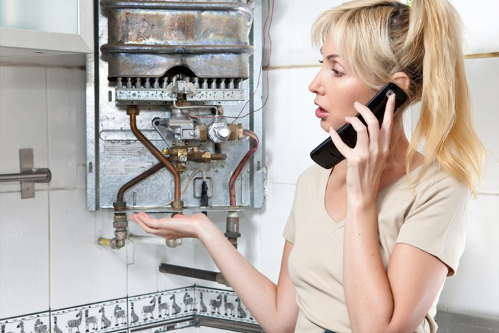 Woman on phone calling about boiler